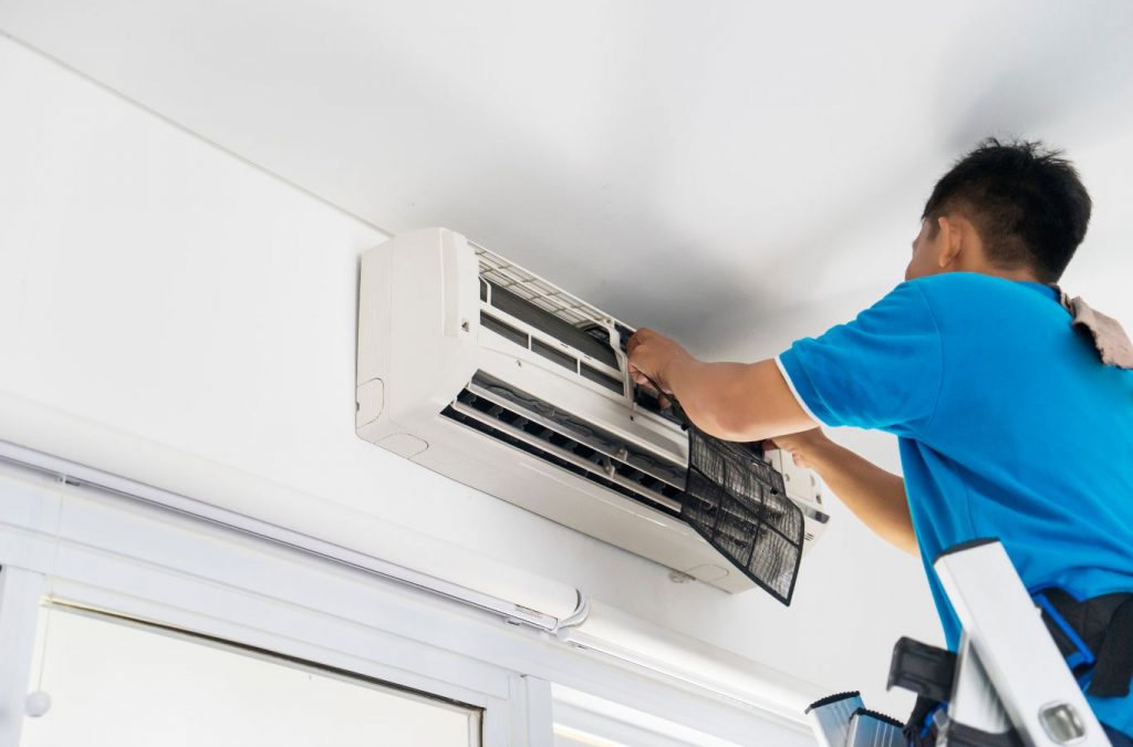 A Climate Systems employee performing AC installation in Franklin Park, PA, showcasing professional tools and expertise for reliable service.