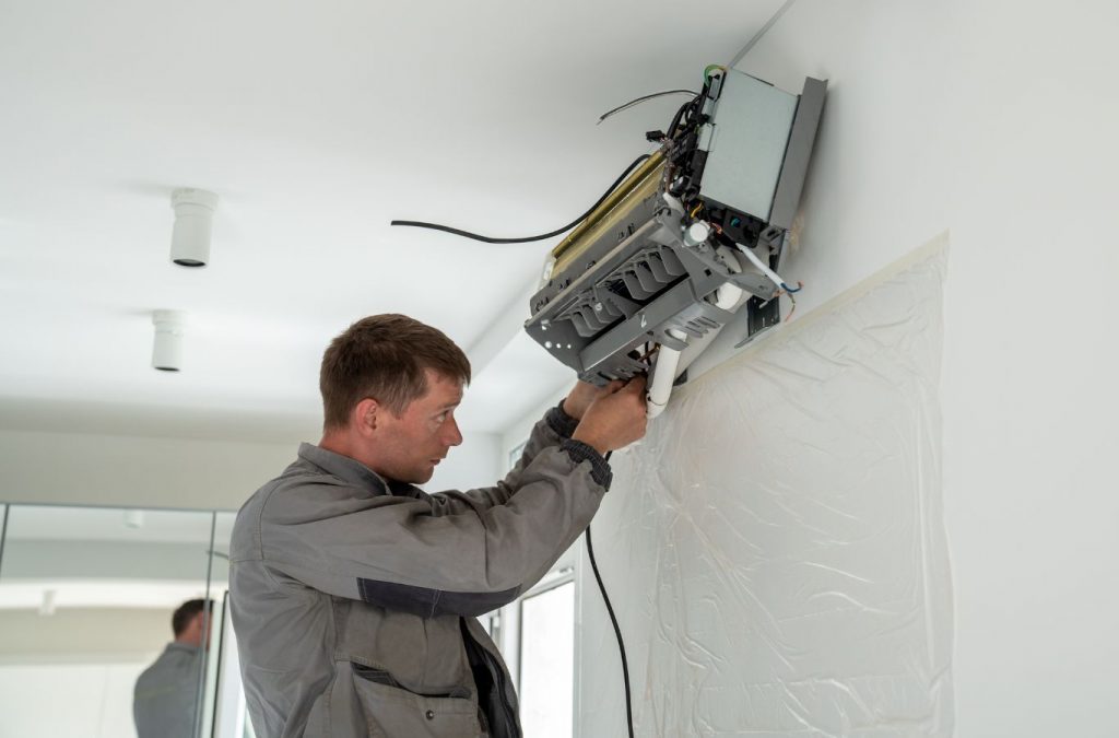 A Climate Systems technician performing AC maintenance in Adams Township, PA, ensuring system efficiency and top-quality service.