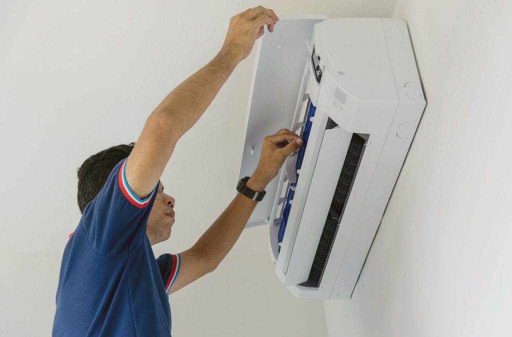 A Climate Systems employee performing AC maintenance in Cranberry Township, PA, ensuring optimal system efficiency and reliable cooling.