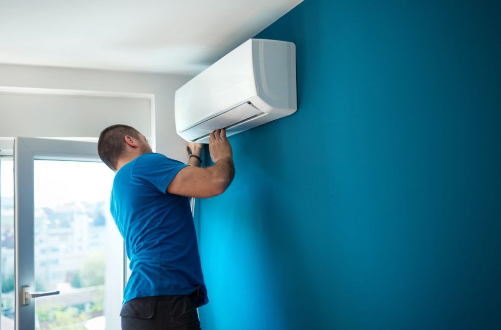 A Climate Systems employee performing AC maintenance in Seven Fields, PA, showcasing professional tools and expertise for top-quality service.