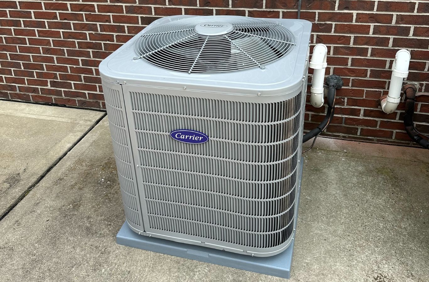 A Climate Systems team member servicing a heat pump in Valencia, PA, demonstrating how timely repair helps ensure long-term comfort and system efficiency.