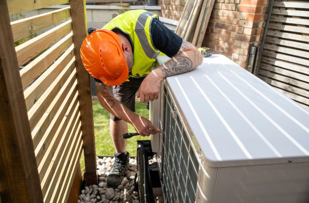 A Climate Systems technician providing heat pump repair in Mars, PA, demonstrating advanced tools and techniques to restore HVAC performance effectively.