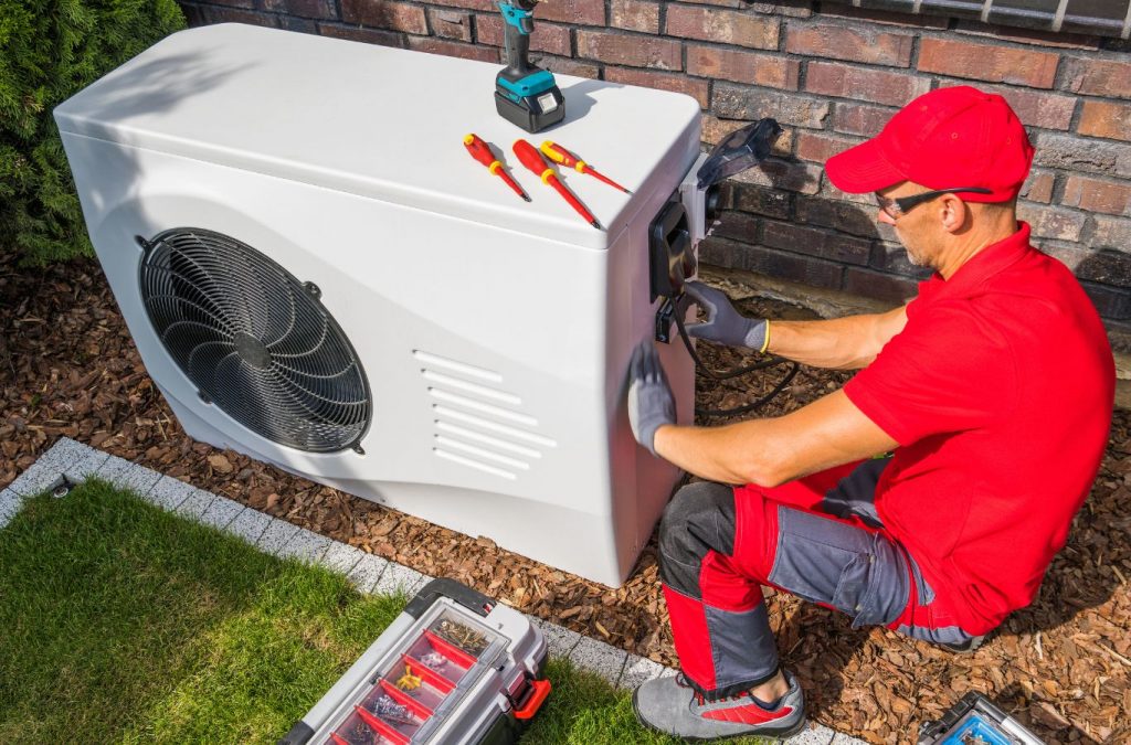 A Climate Systems technician performing heat pump repair in Seven Fields, PA, using professional tools to restore system functionality and efficiency.
