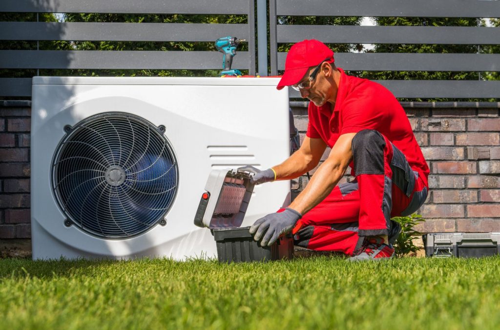 Climate Systems installer setting up a heat pump in Cranberry Township, PA, using expert tools and professional installation for reliable performance.