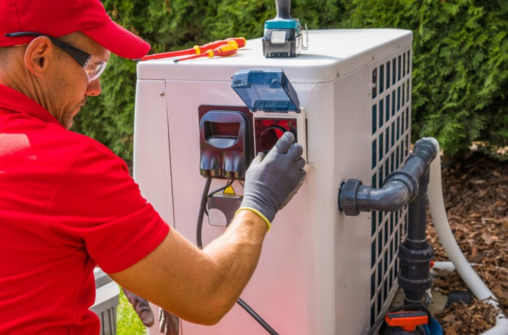 Climate Systems technician installing a heat pump in Valencia, PA, using professional tools and precise setup to ensure effective heating/cooling.